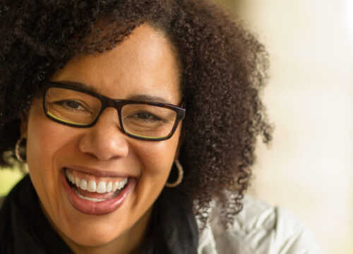Photo of a smiling woman wearing glasses